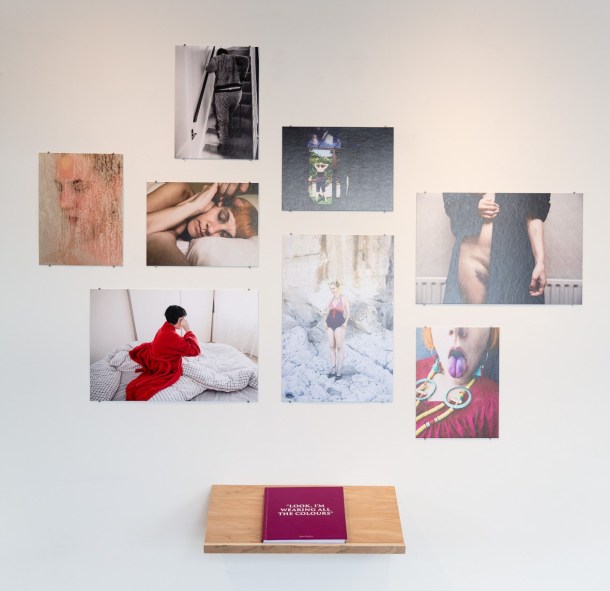 Photobook by Rikard Osterlund with some of the images from the book displayed on the wall.